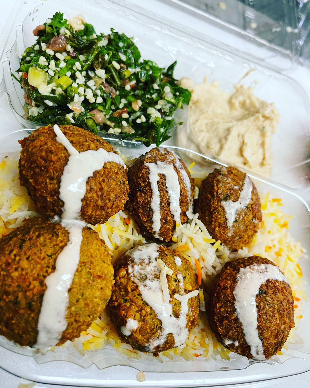 Plated lamb shawarma with fresh sides